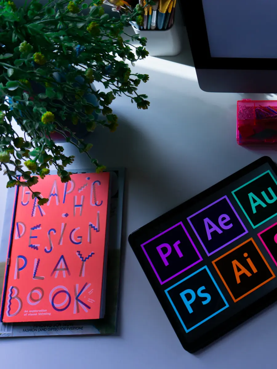 Design tools and a graphic design playbook on a desk.
