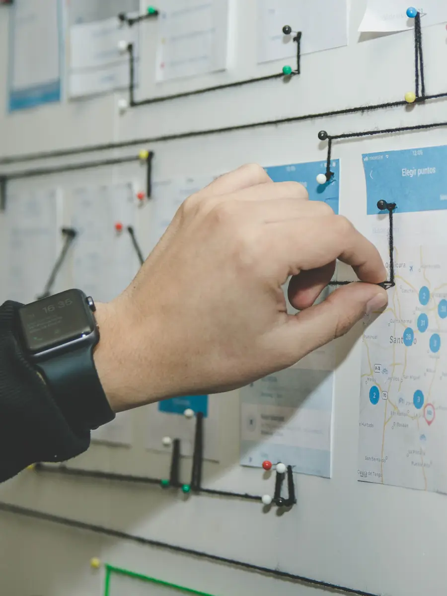 A flow diagram being worked out on a whiteboard wall.